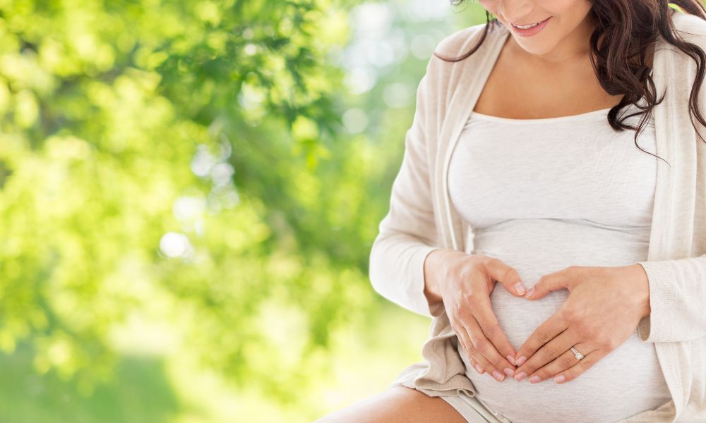 Pregnant women with hands in heart shape